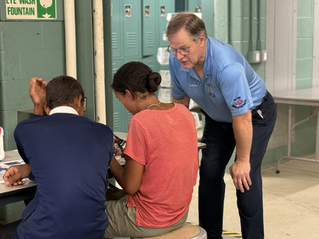 Chris Gray teaching students robotics.
